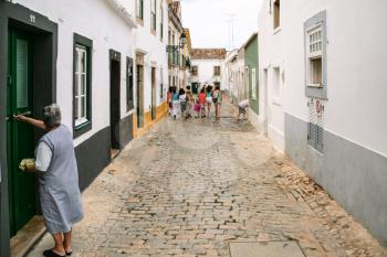 FARO, PORTUGAL - JUNE 25, 2006: people on typical street in historical center of Faro city. Faro is capital of the district of the same name, in the Algarve region of southern Portugal
