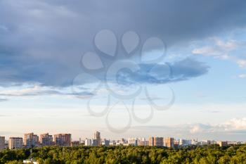 rainy gray cloud in blue evening sky over Bolshaya Akademicheskaya street and Timiryazevsky park in Moscow city in summer