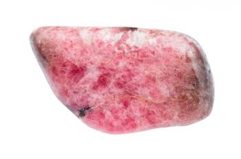 macro shooting of natural mineral stone - tumbled pink rhodonite gemstone from Ural mountains in Russia isolated on white background