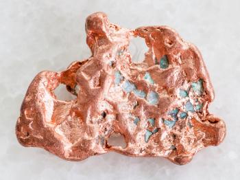 macro shooting of natural mineral rock specimen - copper nugget on white marble background