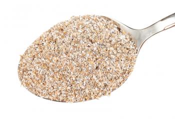 top view of spoon with portion of rye bran close-up isolated on white background