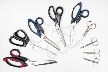 above view of semicircle from different scissors on white background