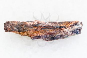 macro shooting of natural mineral rock specimen - raw Schist stone with Kyanite crystal on white marble background