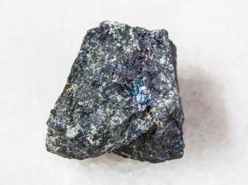 macro shooting of natural mineral rock specimen - rough bornite stone on white marble background from Azerbaijan