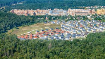 above view of modern cottages and apartment houses in green forest of Moscow Region in Opaliha district of Krasnogorsk town