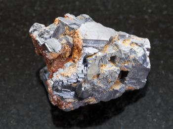 macro shooting of natural mineral rock specimen - raw Galenite stone on dark granite background