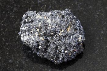 macro shooting of natural mineral rock specimen - crystalline Perovskite stone on dark granite background