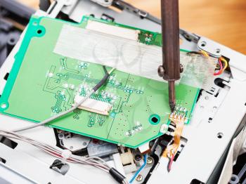 repairing of circuit board with soldering-iron close up