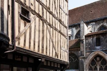 travel to France - old half-timbered house on street Rue Champeaux and wall of church Eglise Saint-Jean-au-Marche in Troyes city