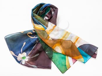 folded hand painted batik silk scarf with abstract floral pattern on white background