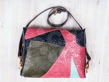patchwork embossed leather ladies bag on gray wooden table
