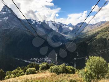 travel to North Caucasus region region - cable way from Moussa-Achitara mount to Dombay resort village in Teberda Nature Reserve in Karachay-Cherkessia region of Russia in september