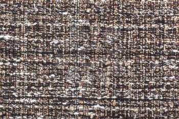 textile background - motley woven yarns of boucle fabric close up