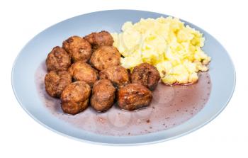 cooked swedish meatballs with lingonberry sauce and mashed potatoes on blue plate isolated on white background