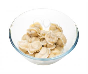 boiled Pelmeni (russian dumplings filled with minced meat) in glass bowl isolated on white background