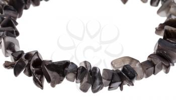 string of beads from natural gray pieces of mother-of-pearl close up isolated on white background