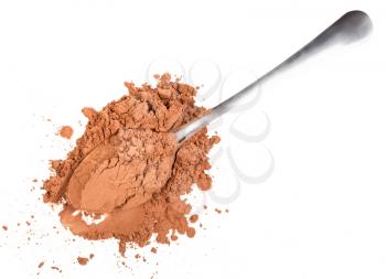 top view of pile of ground carob powder in spoon isolated on white background