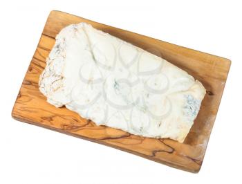top view of piece of local italian Gorgonzola soft blue cheese on olive wood cutting board isolated on white background