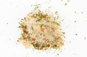 top view of pile of seasoned salt with dried vegetables and flavours on white background