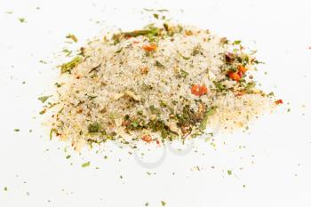 pile of seasoned salt with dried vegetables and flavours on white background