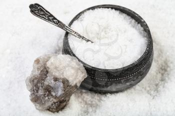 old silver salt cellar with spoon, raw natural Halite mineral and grained Rock Salt close up