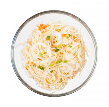 top view of Russian sauerkraut (sour cabbage pickled with carrots and served as salad) in glass bowl isolated on white background