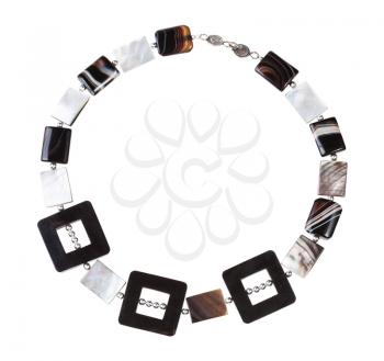 top view of hand crafted necklace from horn frames, silver balls, square striped agate and nacre beads isolated on white background