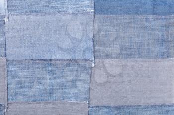 textile background - patchwork from denim flaps