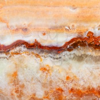 square background from polished natural banded Calcite Onyx rock (onyx marble, Limestone Onyx) close up