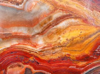 background from polished natural banded Calcite Onyx rock (onyx marble, Limestone Onyx) close up