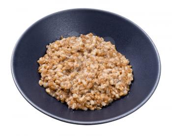 porridge from whole-grain Emmer farro in gray bowl isolated on white background