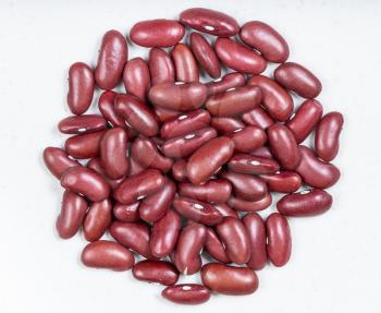 top view of pile of raw kidney beans close up on gray ceramic plate