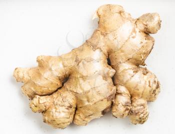 natural fresh whole ginger root on gray plate close up