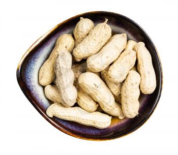 top view of whole peanuts in ceramic bowl isolated on white background