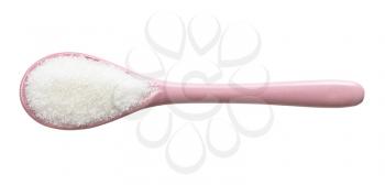 top view of white refined beet sugar in pink ceramic spoon isolated on white background
