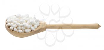 raw tapioca pearls in wooden spoon isolated on white background
