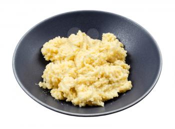 boiled porridge from proso millet groats in gray bowl isolated on white background