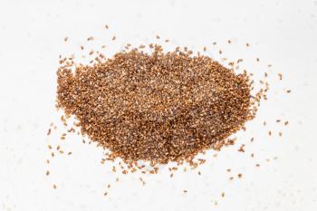 top view of pile of whole-grain teff seeds close up on gray ceramic plate