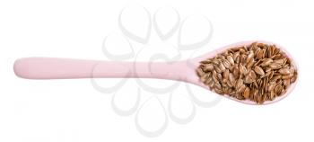 top view of ceramic spoon with brown flax seeds isolated on white background