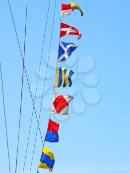 Set of the sea alarm flags on a mast.