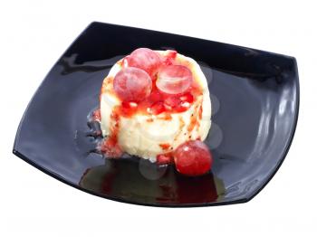 Sweet dessert with fresh grapes berries and pomegranate grains on black plate.Isolated.