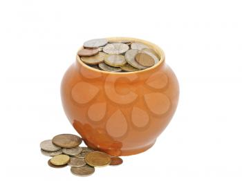Old ceramic pot with metal money isolated on a white background.