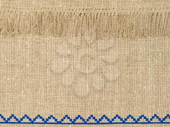 Natural linen texture pattern with fringe as background.