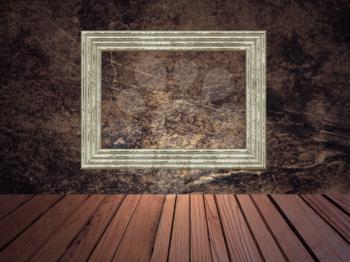 Grunge abstract background with picture frame on wall and wooden plank floor.