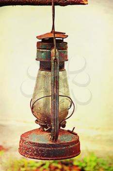 Old vintage kerosene lamp outdoors taken closeup.Toned image.