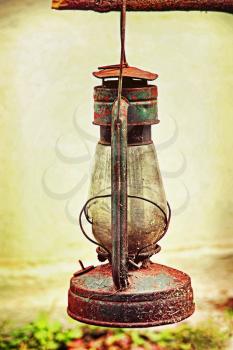 Old kerosene lamp outdoors taken closeup.Toned image.