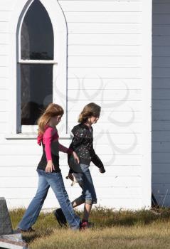 Young girls walking in Saint Agusta Church yard