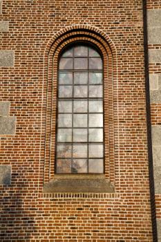  italy  lombardy     in  the  turbigo  old   church   closed brick tower   wall rose   window tile   