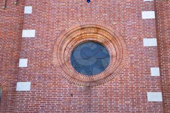  italy  lombardy     in  the  sumirago  old   church   closed brick tower   wall rose   window tile   