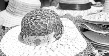 in a old market lots of colorated hats  like background clothes